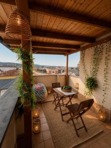 a patio with a table and chairs on a balcony at Apartmány KRAKENS in Šumperk