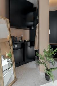 a bathroom with a mirror and a black kitchen at Clyde Athens by Stay Unique in Athens