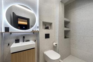 a bathroom with a sink and a mirror and a toilet at Clyde Athens by Stay Unique in Athens +82 photos