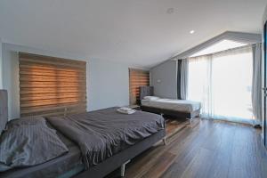 a bedroom with a bed and a large window at Villa ay yıldız in Belek +44 photos