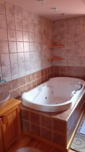 a large bath tub in a bathroom with a sink at Penzión U Jakuba in Kežmarok +17 photos