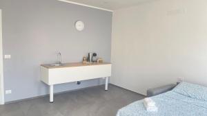 a bathroom with a sink and a desk in a room at CENTRAL LUXURY Rooms in Grugliasco