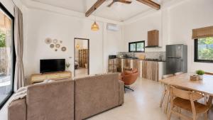 a living room with a couch and a table at Maprao Tropical Home in Ko Phangan