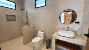 a bathroom with a toilet and a sink and a mirror at Maprao Tropical Home in Ko Phangan +28 photos
