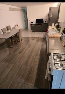 a kitchen with a table and a counter top at Mini vacanta in Tăşnad