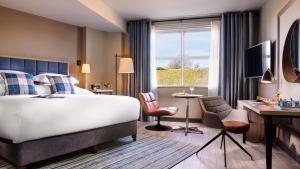 a hotel room with a bed and a desk at Harbour Hotel in Galway +52 photos