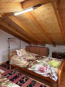 a bed in a room with a wooden ceiling at The Stone Loft in Arfará