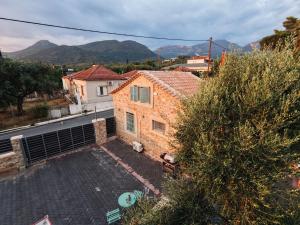 a small brick house with a view of a street at The Stone Loft in Arfará