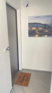 a door with a sign on the floor next to a painting at CENTRAL LUXURY Rooms in Grugliasco