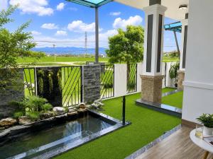 an indoor garden with a koi pond in a house at Homestay ĐAN MY 2 in Trung Nghĩa