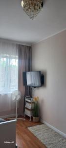 a living room with a flat screen tv on a wall at Apartament Wiejski Raj in Kozy