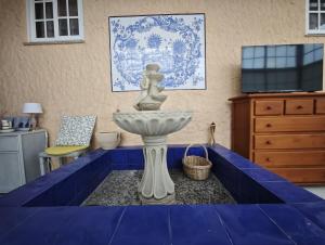 a table with a blue table cloth around a sink at Chalet cerca de la playa de Esmelle in Pedreira +42 photos
