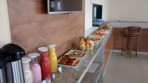 a buffet with drinks and pastries on a counter at Pousada Da Serra in Bananeiras