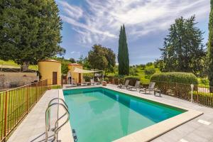 a swimming pool with a fence around it at Casa Febea in Chiusi