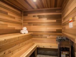 a wooden sauna with a teddy bear sitting in it at Swiss Marmot in Glacier
