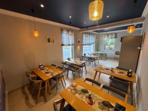 an empty restaurant with wooden tables and chairs at Serce in Sokółka +37 photos