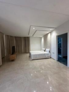 a bedroom with a bed and a television in it at Dar Llama in Nador