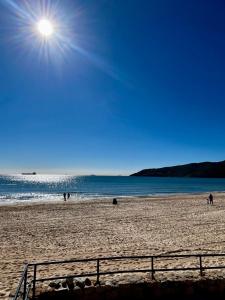 people on a beach with the sun in the sky at Centro Kennedy in Algeciras +4 photos