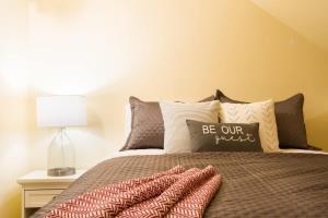 a bedroom with a bed with pillows and a lamp at Rivers Edge at Snowater in Glacier