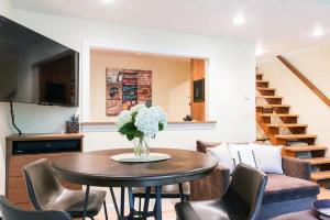 a living room with a table and chairs at Rivers Edge at Snowater in Glacier