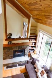 a living room with a stone fireplace in a house at Rivers Edge at Snowater in Glacier +22 photos