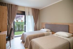 a hotel room with two beds and a window at Da Niko in Treviso