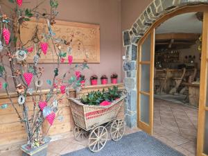 a welcoming entry to a home with a basket of plants at Penzión U Jakuba in Kežmarok