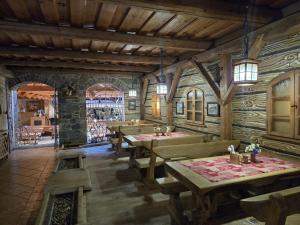 a restaurant with tables and chairs in a room at Penzión U Jakuba in Kežmarok