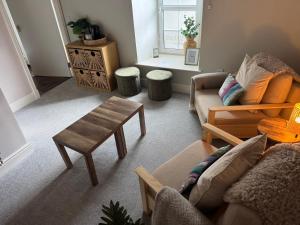 a living room with two couches and a table at Tweedside in Innerleithen