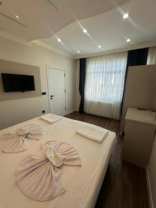 a bedroom with a bed with two bows on it at Kumkapı Hotel - Special Category in Istanbul