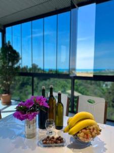 a table with a bunch of bananas and bottles of wine at Golden Horizon in Ts'ikhisdziri