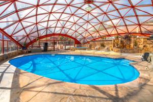 an indoor swimming pool with a glass roof at Baymont by Wyndham Durango in Durango