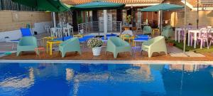 a group of chairs and tables next to a pool at TUSCIA RELAx MARE in Civitavecchia