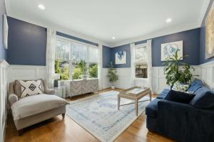 a blue living room with a couch and a chair at The Classy Craftsman - Beautiful Decor & Pool in Atlanta