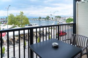 a balcony with a table and a view of a harbor at Villa Theodora Boutique Stay in Fanari