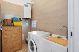 a laundry room with a washing machine and a sink at DIEGOPAS Sweet Home in SantʼAntonio Abate
