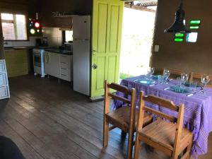 a kitchen with a table with a purple table cloth at Casas de barro in La Pedrera