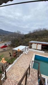 a house with a swimming pool and two tables at Terrazas Jorge y Claudia in Bialet Massé