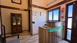 a bar with a counter in a room with a door at Residencial Borges Canela in Canela