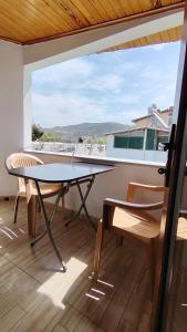 a table and chairs on a balcony with a view at Avsa BARAN MOTEL apart in Marmara