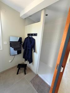 a room with a robe hanging on a wall at Gite le3chênes in Remoncourt