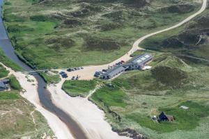 an aerial view of a road next to a river at Henne Mølle Å Badehotel in Henne Strand