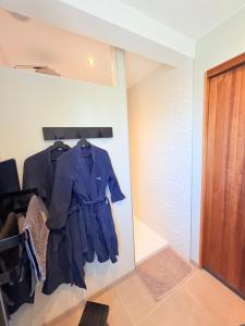 a room with a suit hanging on a wall at Gite le3chênes in Remoncourt