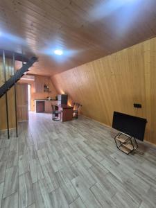 a large room with wooden walls and a wooden floor at Eco Villa, A frame with barbecue zone and pool in Yerevan