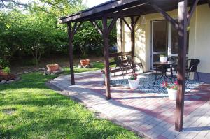 a pergola on a patio with a table at Laskowy Sad pokoje gościnne agroturystyka in Wieniec