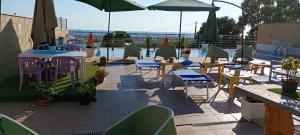 a patio with tables and chairs and a pool at TUSCIA RELAx MARE in Civitavecchia