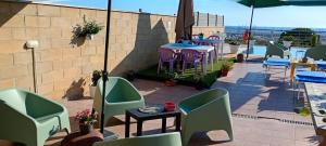 a patio with chairs and tables and a table and chairs at TUSCIA RELAx MARE in Civitavecchia