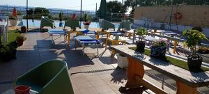 a patio with chairs and tables and a table and chairs at TUSCIA RELAx MARE in Civitavecchia +35 photos