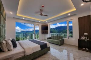 a bedroom with a large bed and a balcony at Hotel Luxe Vista Dalhousie in Dalhousie