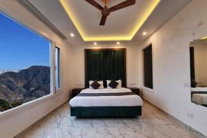 a bedroom with a bed and a large window at Hotel Luxe Vista Dalhousie in Dalhousie